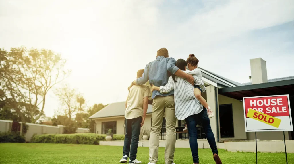 Family standing out the front of their newly purchased rural property in Queensland.